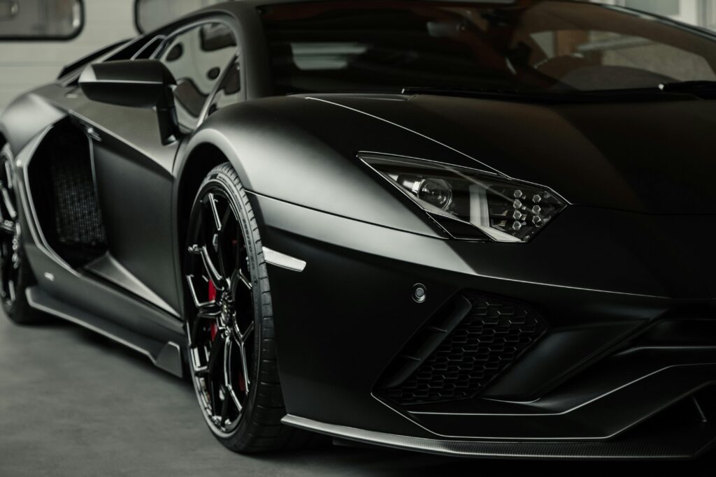 pexels-photo-26954168-26954168 Close-up of a sleek black sports car, highlighting luxurious design and detail.